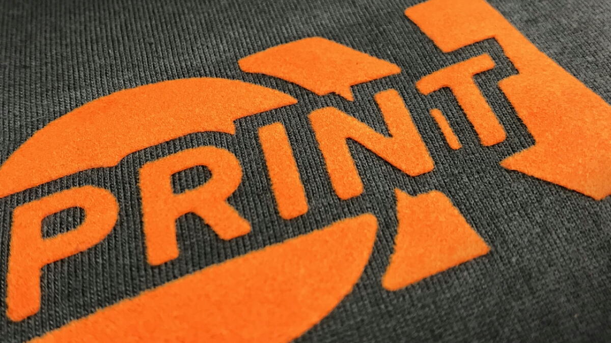 Print on logo in orange flock on dark grey sweater